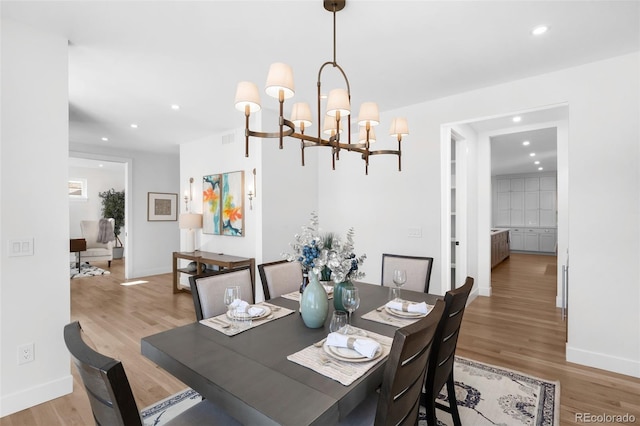 dining room featuring a chandelier and light wood-type flooring