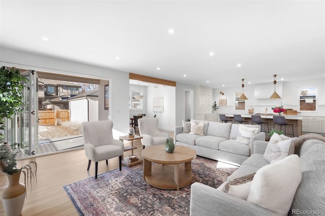 living room with sink and light hardwood / wood-style floors