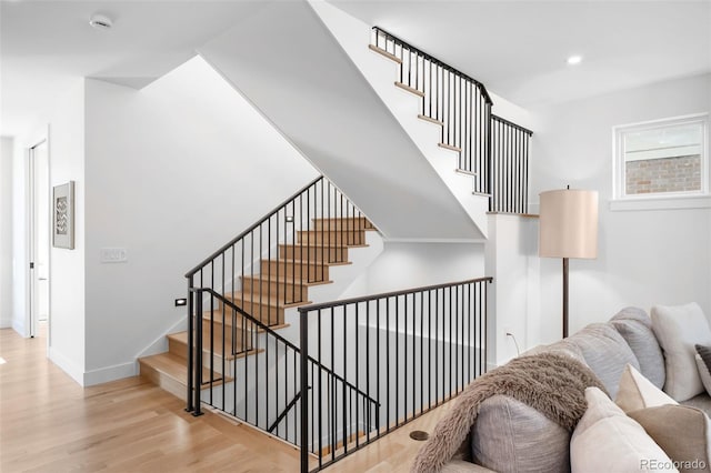 staircase with hardwood / wood-style flooring