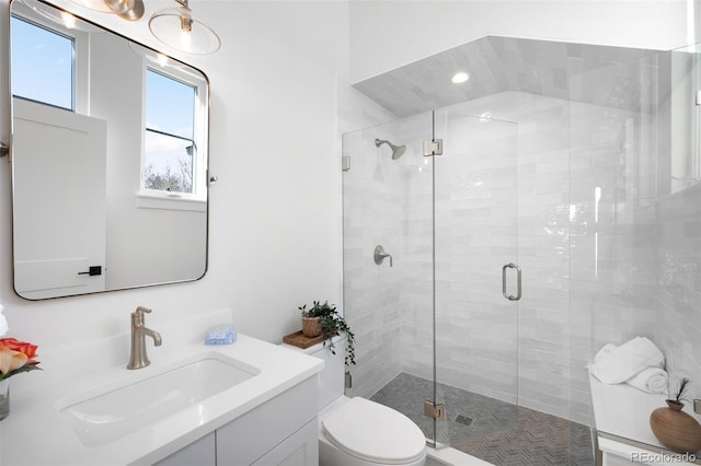 bathroom with vanity, toilet, and walk in shower