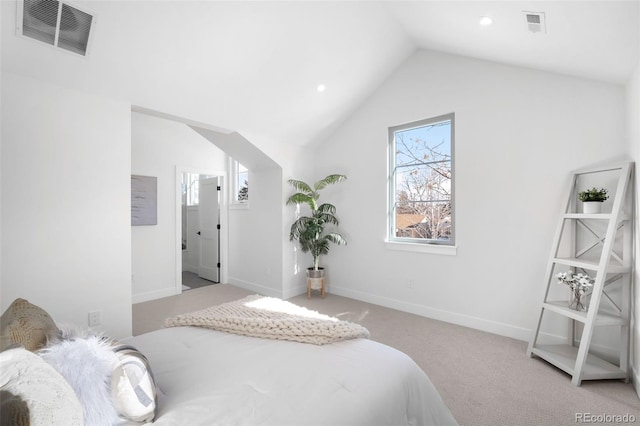 carpeted bedroom with vaulted ceiling