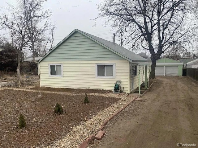 view of property exterior featuring a garage and an outdoor structure