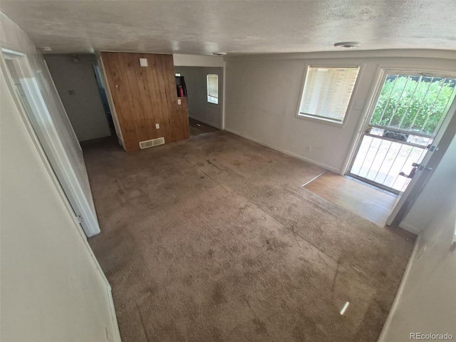 444 S Jersey St, Denver, CO 80224 - unfurnished living room featuring carpet flooring, a textured ceiling, and baseboards