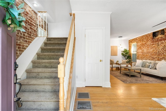 3375 W 37th Ave, Denver, CO 80211 - stairs with brick wall, wood finished floors, and baseboards