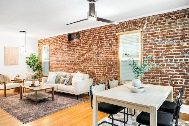 3375 W 37th Ave, Denver, CO 80211 - living room with brick wall, light wood-style flooring, ceiling fan, and ornamental molding