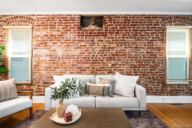 3375 W 37th Ave, Denver, CO 80211 - living area with ornamental molding, baseboards, brick wall, and wood finished floors