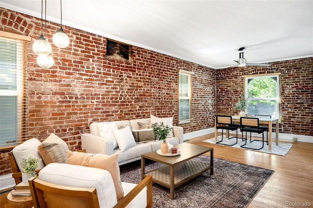 3375 W 37th Ave, Denver, CO 80211 - living room featuring brick wall, baseboards, wood finished floors, ceiling fan, and a textured ceiling