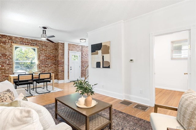 3375 W 37th Ave, Denver, CO 80211 - living room with brick wall, a ceiling fan, light wood-style flooring, baseboards, and ornamental molding