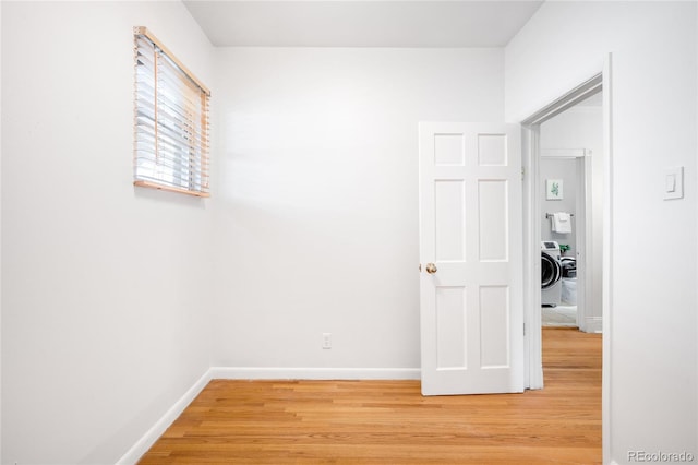 3375 W 37th Ave, Denver, CO 80211 - corridor with light wood-style flooring, baseboards, and washer / clothes dryer