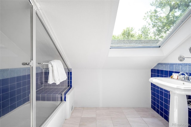3375 W 37th Ave, Denver, CO 80211 - bathroom featuring tile walls, a skylight, shower / bath combination with glass door, a wainscoted wall, and a sink
