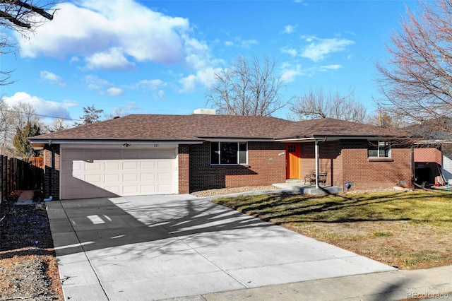 ranch-style home featuring a garage and a front lawn