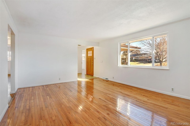 spare room featuring light hardwood / wood-style flooring