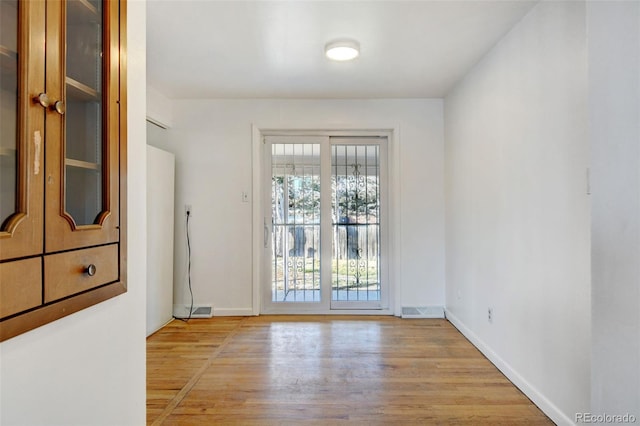 doorway to outside with light hardwood / wood-style floors