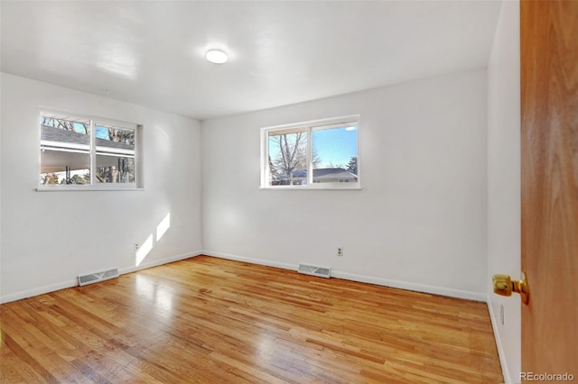 spare room featuring light hardwood / wood-style flooring