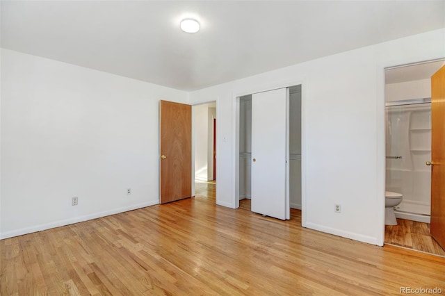 unfurnished bedroom with connected bathroom and light hardwood / wood-style floors