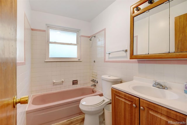 full bathroom with vanity, tiled shower / bath, decorative backsplash, toilet, and tile walls