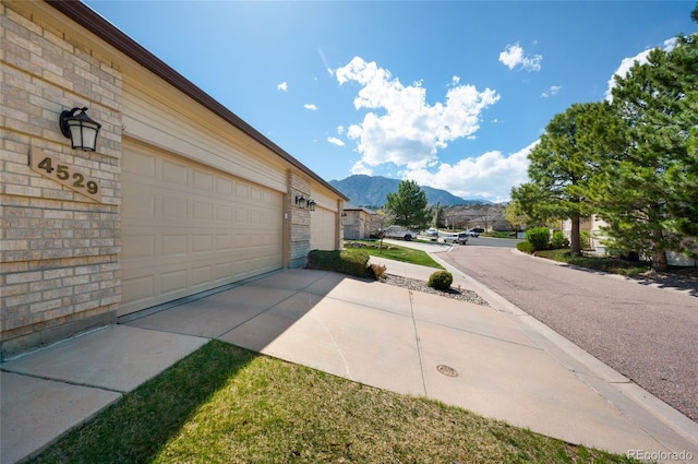 4529 Songglen Cir, Colorado Springs, CO 80906 - garage featuring a mountain view and concrete driveway