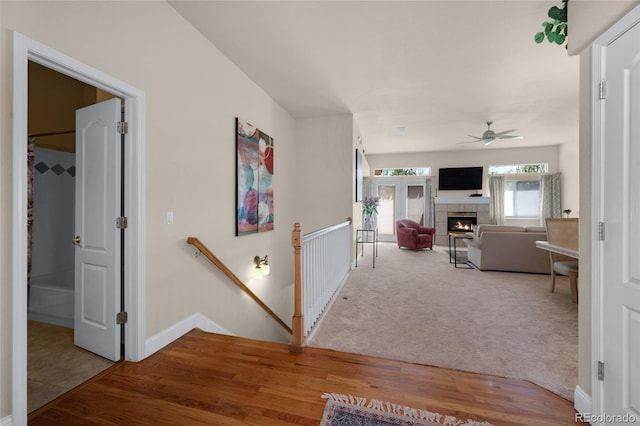 4529 Songglen Cir, Colorado Springs, CO 80906 - corridor featuring an upstairs landing, wood finished floors, baseboards, and carpet flooring