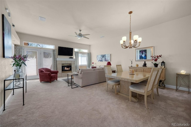 4529 Songglen Cir, Colorado Springs, CO 80906 - dining area featuring a fireplace, light colored carpet, a chandelier, and ceiling fan