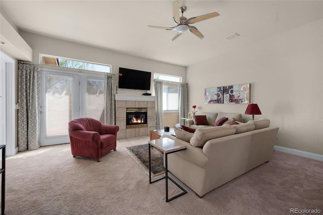4529 Songglen Cir, Colorado Springs, CO 80906 - living area with light carpet, a ceiling fan, a tiled fireplace, and baseboards