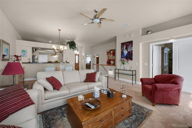 4529 Songglen Cir, Colorado Springs, CO 80906 - carpeted living area with a chandelier, ceiling fan, and baseboards