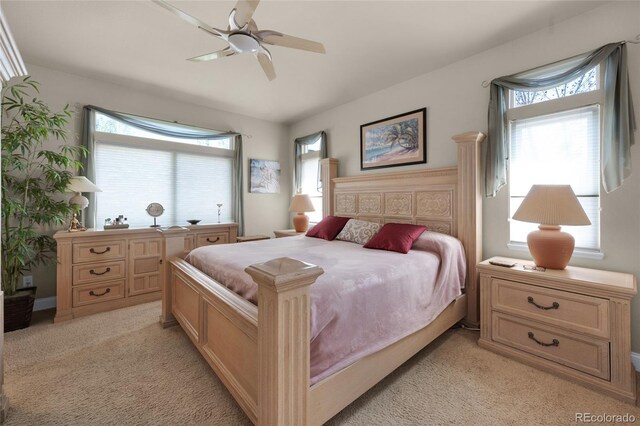 4529 Songglen Cir, Colorado Springs, CO 80906 - bedroom featuring light carpet, multiple windows, and a ceiling fan