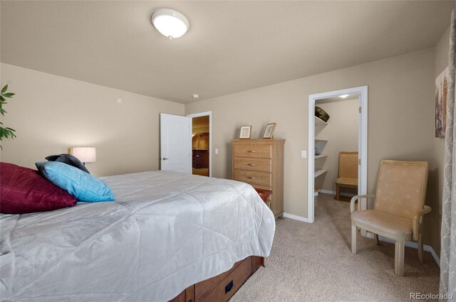 4529 Songglen Cir, Colorado Springs, CO 80906 - bedroom featuring a walk in closet, light colored carpet, and baseboards