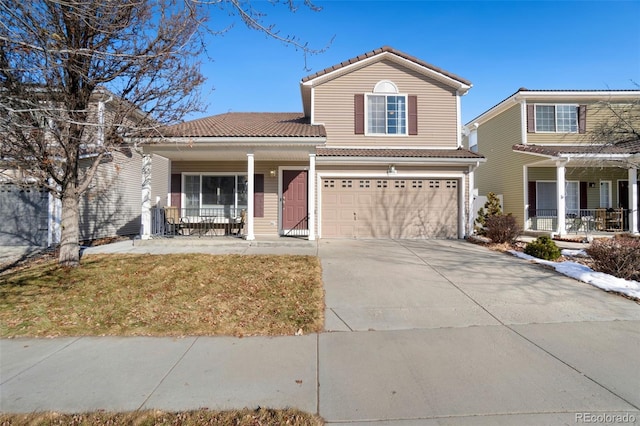 view of property with a front yard, a garage, and a porch