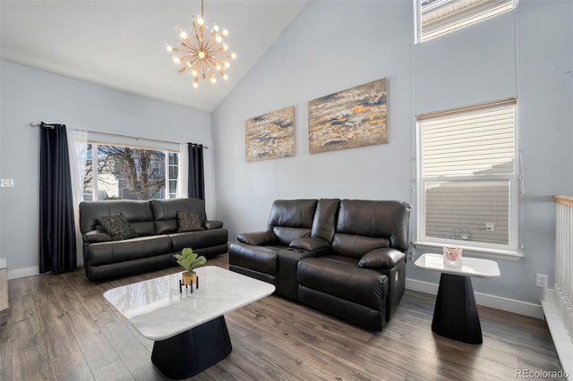 living room with hardwood / wood-style flooring, high vaulted ceiling, and a chandelier