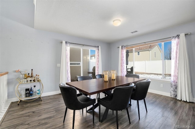 dining area featuring dark hardwood / wood-style flooring