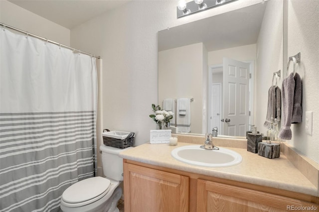 bathroom featuring toilet and vanity