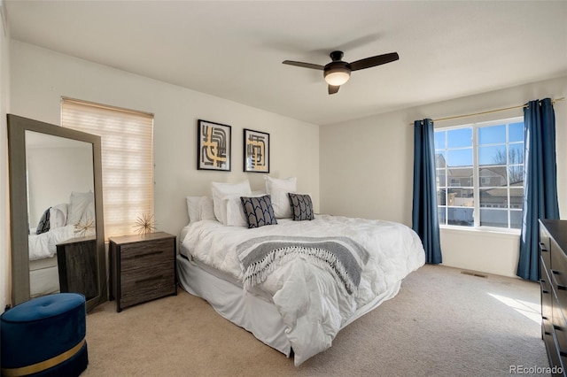 bedroom featuring ceiling fan and light carpet