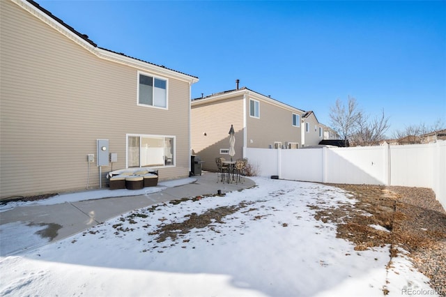 view of snow covered back of property