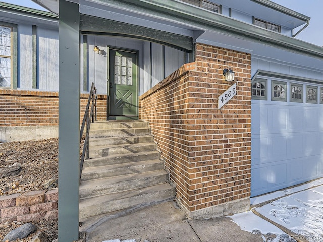 doorway to property with a garage