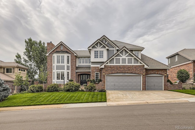 tudor home featuring a front lawn