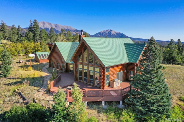 rear view of property with a deck with mountain view