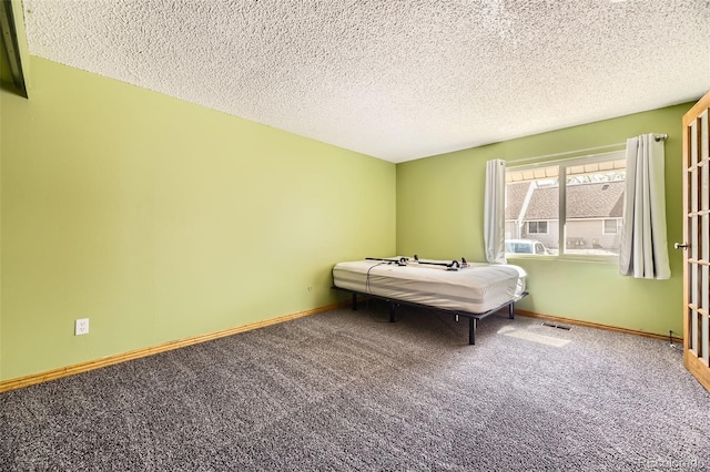 2469 S Xanadu Way Unit A, Aurora, CO 80014 - bedroom with carpet, a textured ceiling, and baseboards