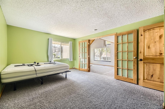 2469 S Xanadu Way Unit A, Aurora, CO 80014 - bedroom with carpet, a textured ceiling, and baseboards