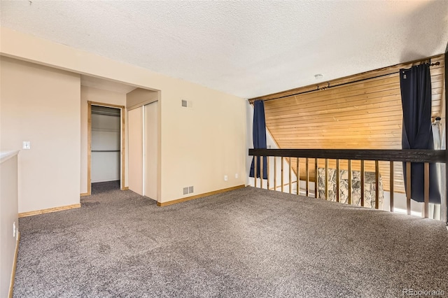 2469 S Xanadu Way Unit A, Aurora, CO 80014 - carpeted empty room with baseboards and a textured ceiling