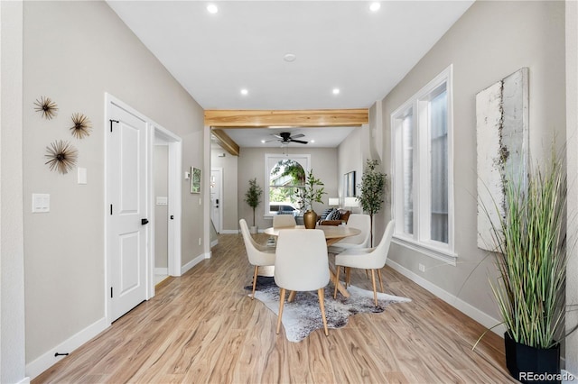 dining space featuring beamed ceiling and light hardwood / wood-style flooring