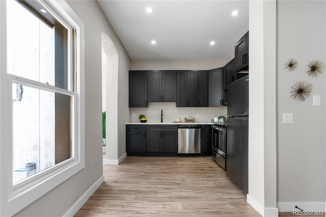 kitchen with sink, light hardwood / wood-style flooring, and stainless steel appliances