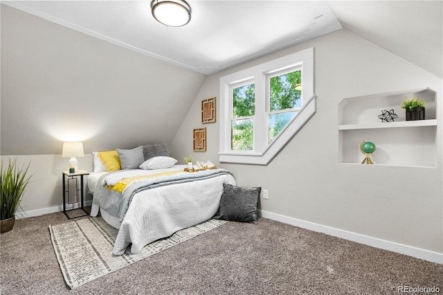 bedroom with vaulted ceiling and carpet flooring