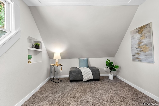 sitting room featuring vaulted ceiling, carpet, and built in features