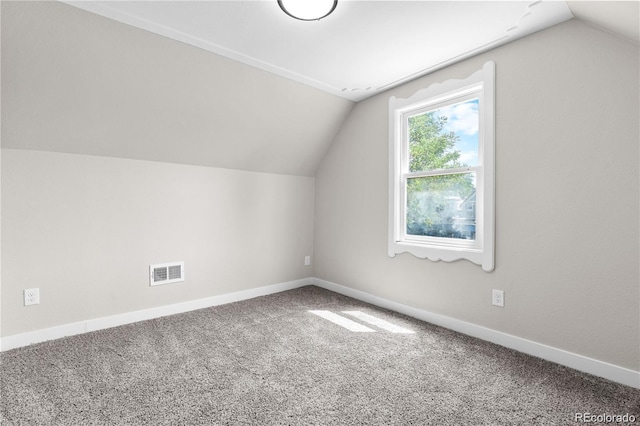 bonus room featuring vaulted ceiling and carpet flooring