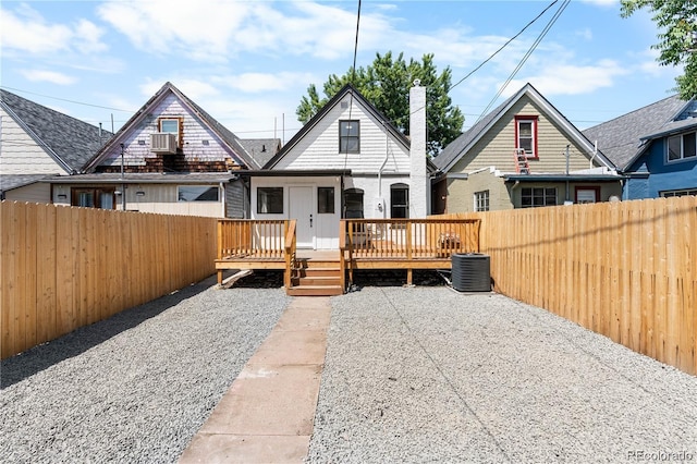 back of house featuring cooling unit and a deck