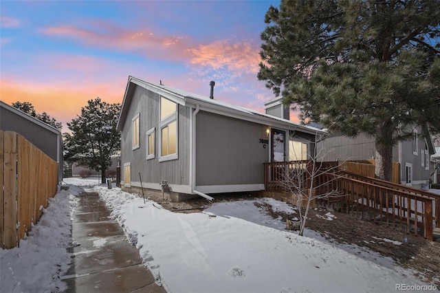 exterior space with a chimney and fence