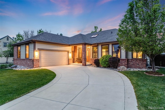 236 E Fair Ln, Centennial, CO 80121 - view of front of house featuring brick siding, a garage, a lawn, and driveway