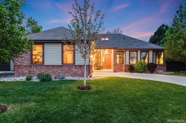 236 E Fair Ln, Centennial, CO 80121 - view of front facade with brick siding, a front lawn, concrete driveway, and roof with shingles