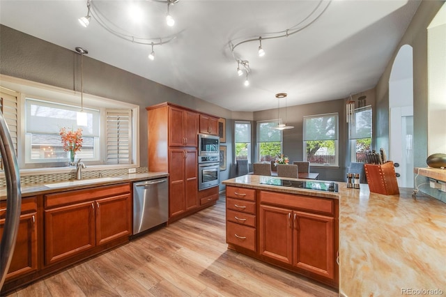 236 E Fair Ln, Centennial, CO 80121 - kitchen with stainless steel appliances, a sink, light countertops, and light wood-style flooring