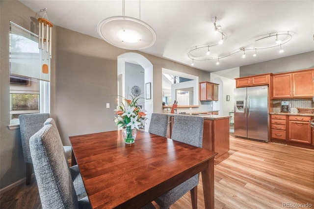 236 E Fair Ln, Centennial, CO 80121 - dining space with arched walkways and light wood finished floors
